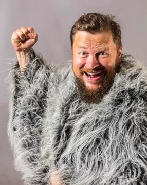 Solid bearded man in a fur mantle studio emotional Stock Photos