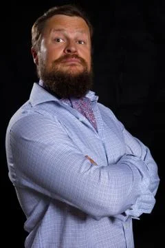 Solid bearded man in shirt smiling studio portrait on black background. Foto stock