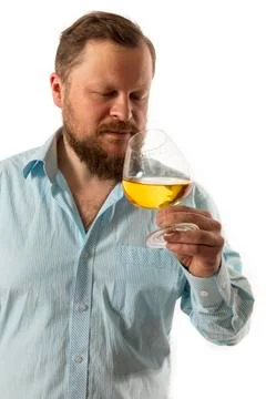 Solid bearded man in shirt tasting whisky studio portrait Stock Photos