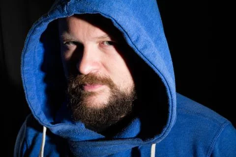 Solid bearded middle-aged man in a hood  portrai Stock Photos