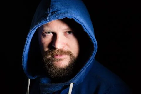 Solid bearded middle-aged man in a hood  portrai Stock Photos