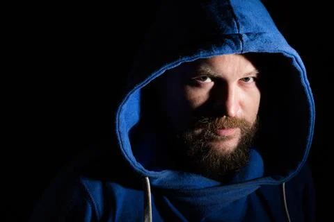 Solid bearded middle-aged man in a hood  portrai Stock Photos