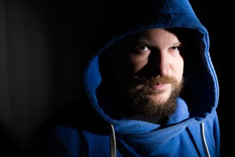 Solid bearded middle-aged man in a hood  portrai Stock Photos