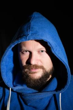 Solid bearded middle-aged man in a hood  portrai Stock Photos