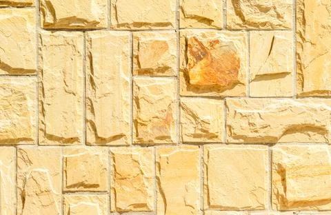 Solid beige and brown stone wall. Suitable for background Stock Photos