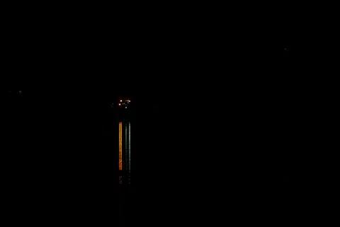 Solid black background with small distant coloured lights and long coloured.. Stock Photos