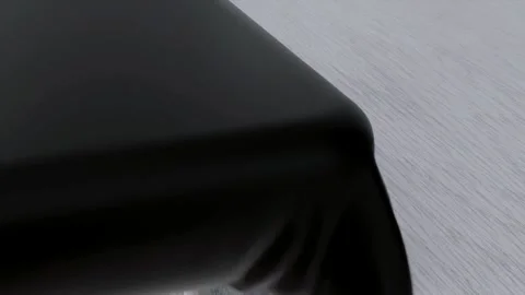 Solid Black Cloth Draping onto White Marble Table Video Stock Footage 337636901