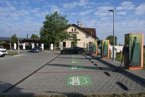 A solid black Tesla Model 3 charging at the Prague V4 Supercharger Stock Photos
