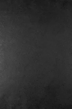 Solid black textured background with subtle variations in surface detail, i.. Stock Photos