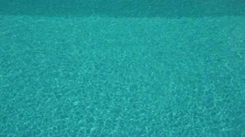 Solid blue turquoise background of the water surface shimmers in the sun, 4к Stock Footage 178586266