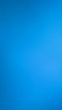 Solid bright blue background texture with smooth gradient lighting. Stock Photos