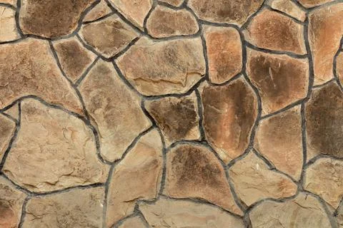 Solid brown and beige stone wall. Suitable for background Stock Photos
