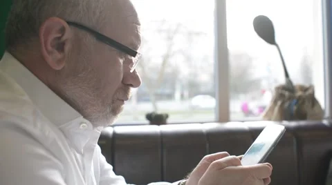 Solid business Man chating, writing sms on a Cell Mobile Phone sitting in a cafe Stock Footage 61305954