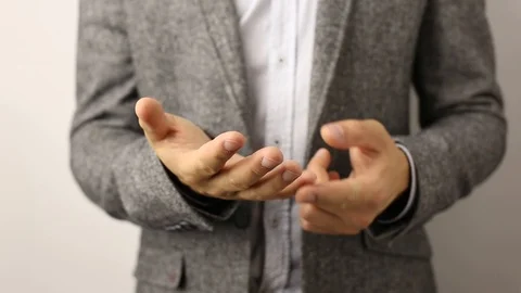 Solid caucasian man in gray jacket and speckled shirt on white background slowly Stock Footage 114227173