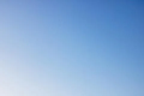 Solid color bright blue sky, background or texture Stock Photos