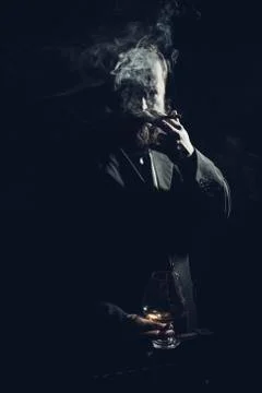 Solid confident bearded man in suit with glass of whisky and cigar Stock Photos