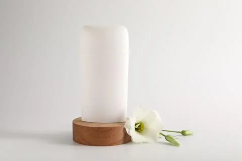 Solid deodorant and beautiful eustoma flower on white background 스톡 사진
