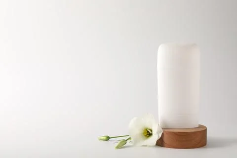 Solid deodorant and beautiful eustoma flower on white background, space for.. 스톡 사진
