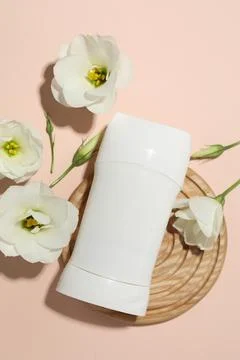 Solid deodorant and beautiful eustoma flowers on beige background, flat lay 스톡 사진