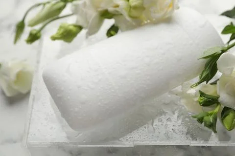Solid deodorant and beautiful eustoma flowers on table, closeup Stock Photos
