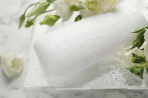 Solid deodorant and beautiful eustoma flowers on table, closeup Stock Photos