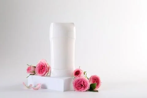 Solid deodorant and beautiful rose flowers on white background Stock Photos