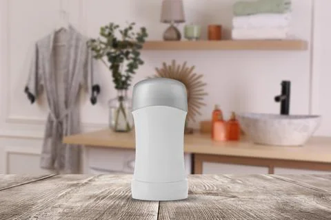 Solid deodorant on wooden table in bathroom. Mockup for design Stock Photos