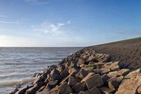 Solid dike of boulders and stone Stock Photos