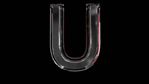 Solid glass alphabet - letter U isolated on black background Video stock 166168617