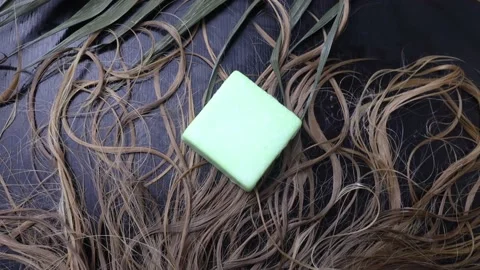 Solid hair shampoo. Composition of golden curls, soap suds, solid shampoo and co Stock Footage 180557755