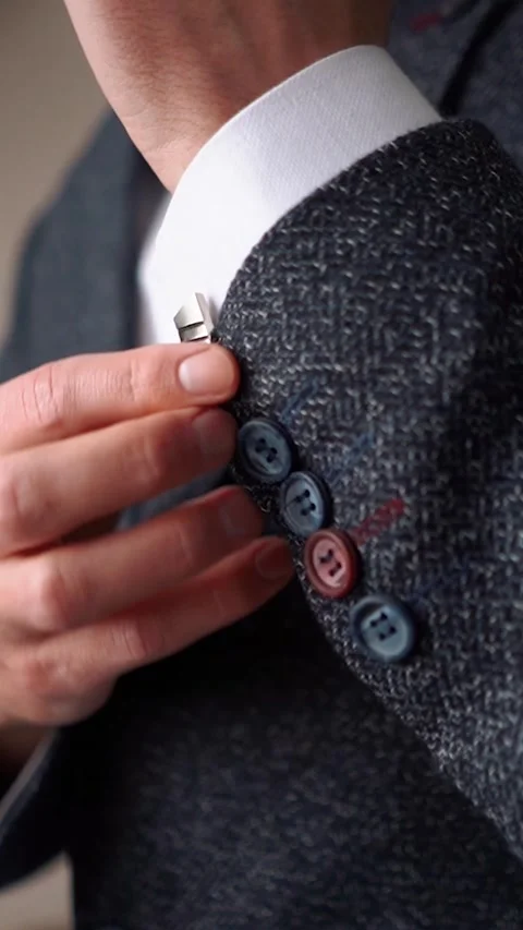 Solid handsome man groom in a business suit jacket straightens his tie in the Stock Footage 252268074