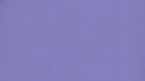 Solid lavender background with faint specks. Stock Photos