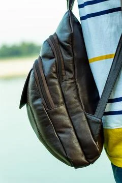 A solid leather bag or carrying bag showing on the man back and stand Stock Photos