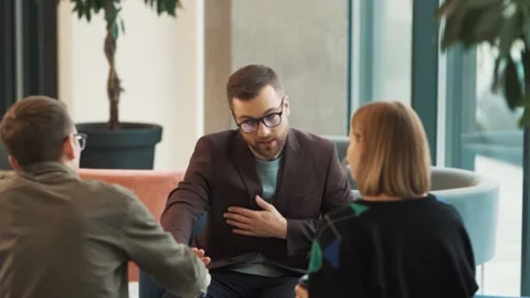 A solid man in a business suit and glasses refuses to take cash from a Stock Footage 221805091