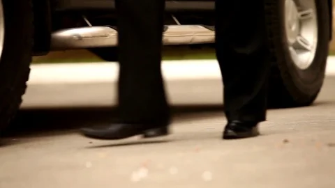 A solid man comes out of an expensive black car Stock Footage 77076537