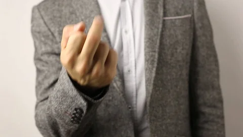 Solid man in gray jacket on white background showing his middle finger Stock Footage 114189208