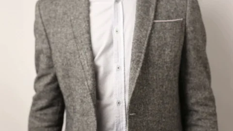 Solid man in gray jacket on white background showing his middle fingers on both Stock Footage 114189288