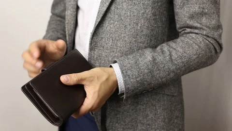 Solid man in gray jacket on white background counting US dollars banknotes Stock Footage 115659835