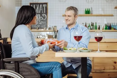 Solid man making a surprise to a lady Foto stock