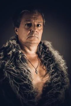Solid middle-aged man in a fur mantle Stock Photos