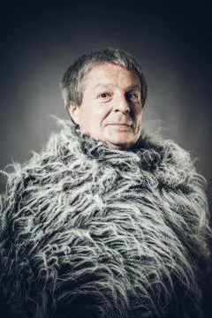 Solid middle-aged man in a fur mantle Stock Photos