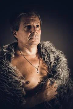 Solid middle-aged man in a fur mantle Stock Photos