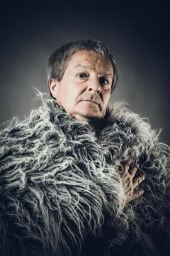 Solid middle-aged man in a fur mantle Stock Photos