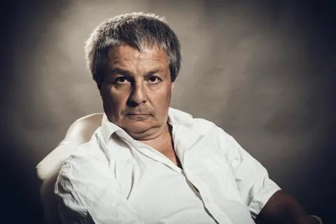 Solid middle aged man studio portrait on grey background. Stock Photos