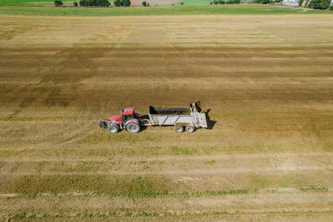 Solid organic fertilizers were brought to the field by a tractor, and manure  Stock Photos