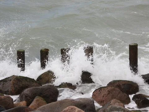Solid poles and rocks at Northern Ocean Stock Photos