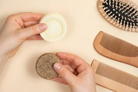 Solid shampoo and conditioner for hair in the hands. Natural cosmetics without Stock Photos