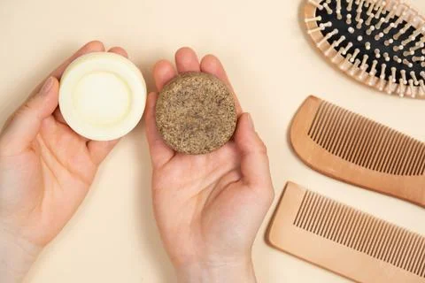Solid shampoo and conditioner for hair in the hands. Natural cosmetics without Stock Photos