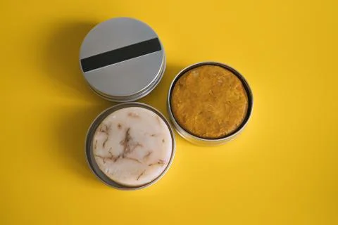 Solid shampoo and soap bars in reusable aluminum jars. Stock Photos