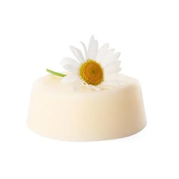 Solid shampoo bar and chamomile isolated on white. Hair care 写真素材